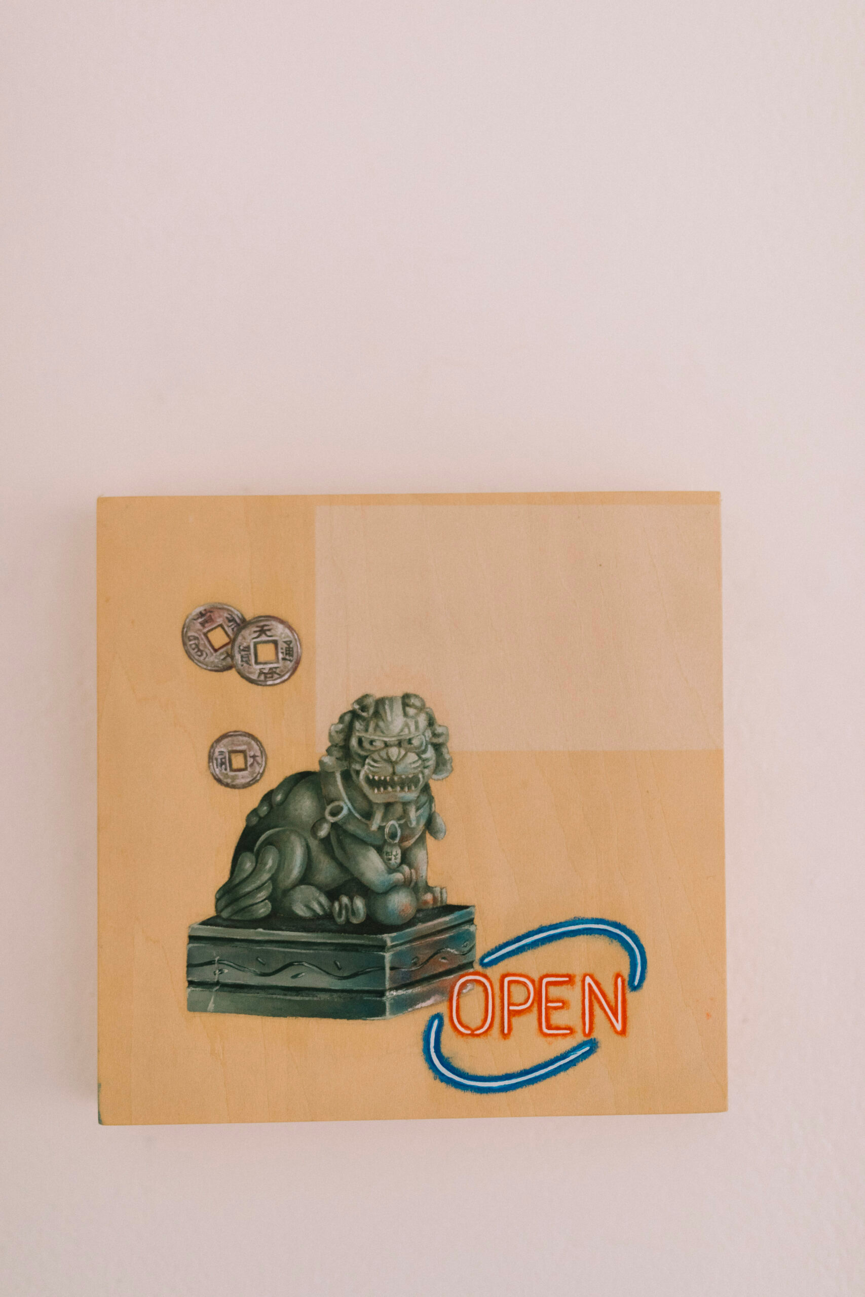 A painting of a gargoyle statue and chinese lucky coins on pine board.