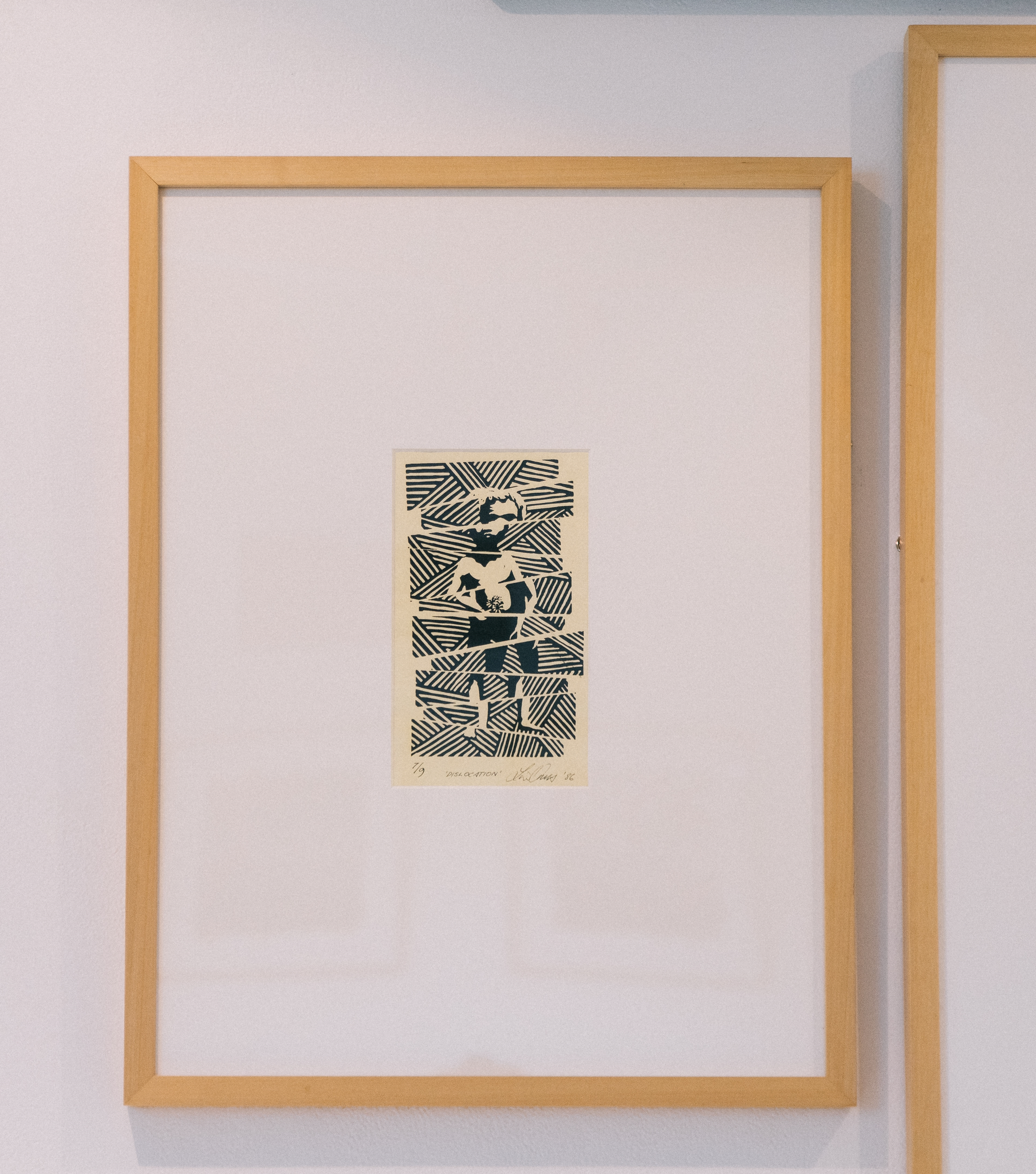 Timber framed linoprint presented with a vertical orientation. The print is black on cream paper and is a spliced image of a young person.