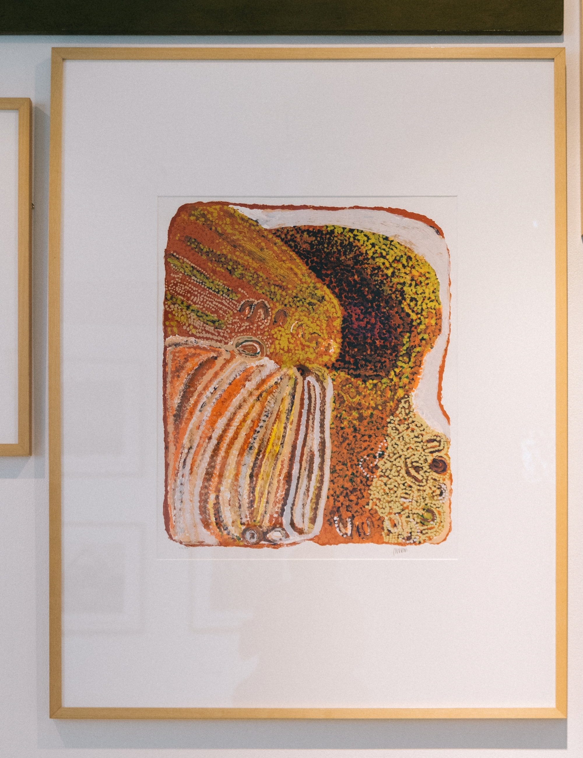 Timber framed, vertically presented colourful screenprint. An abstract image of browns, reds, yellows, whites and orange colours with delicate dots and details.