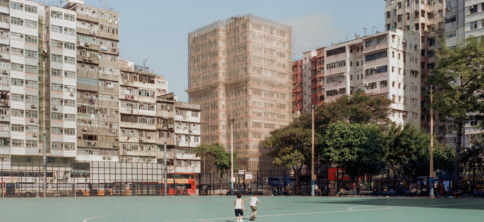 Colour photograph of a city scape and basketball court
